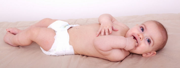 Новорожденный лежит в марлевом подгузнике