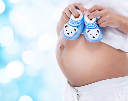 беременная женщина с голубыми пинетками