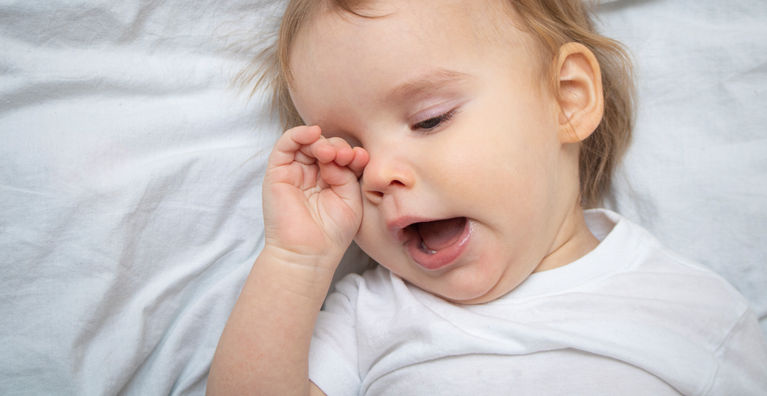 ребенок зевает и трет глазки